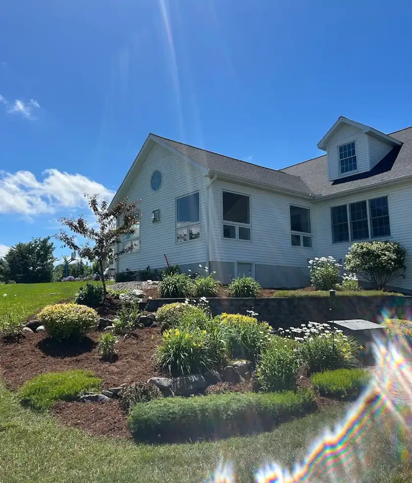 Square stone fire pit and interlocking brick patio built in an Edmonton residential backyard.