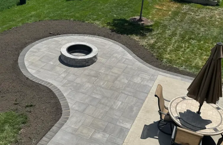 Interlocking paver patio with fire pit and retaining wall in Edmonton.