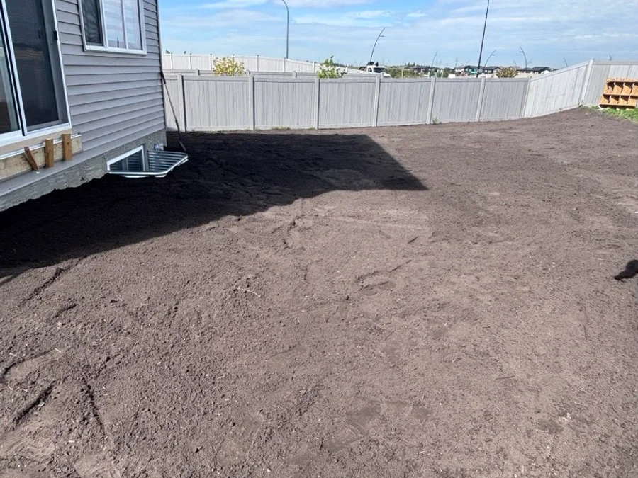 Final grading and topsoil placement completed for a new home in Rivers Edge, Edmonton.