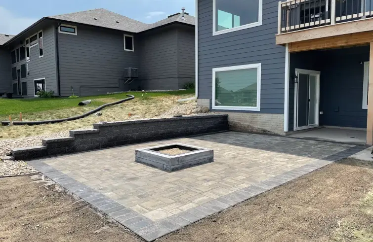 Interlocking paver patio with fire pit and retaining wall in Edmonton.