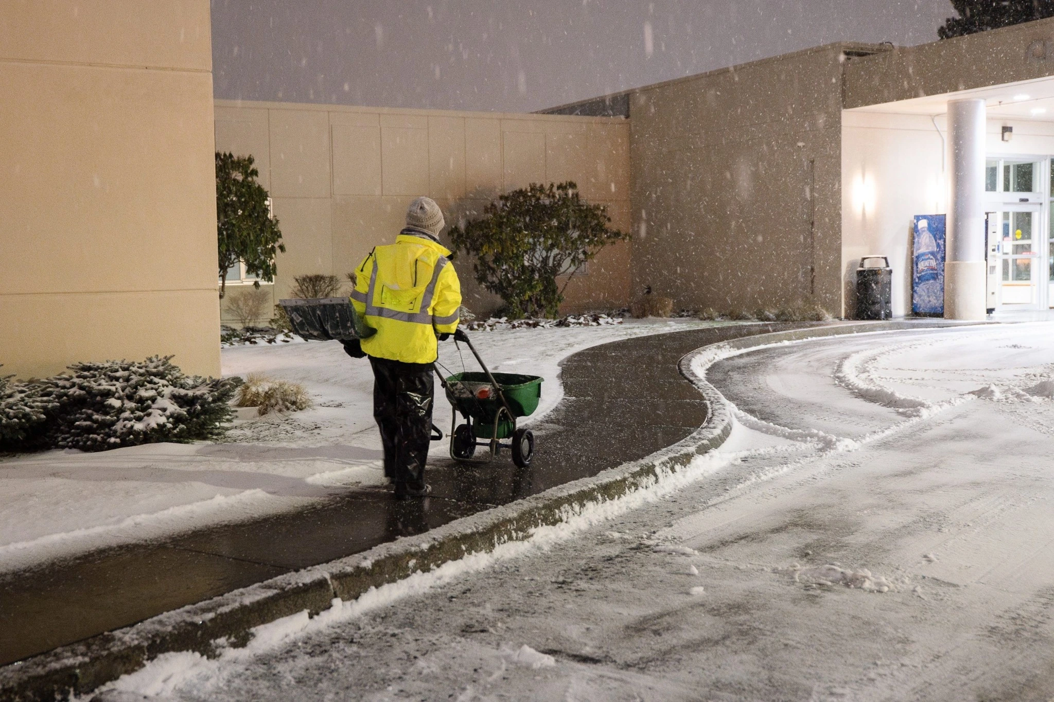 Snow removal crew clearing a residential driveway in Edmonton.